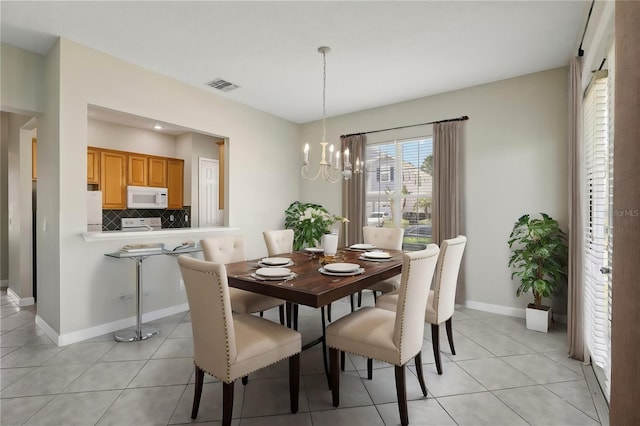 dining room featuring a notable chandelier and light tile patterned floors