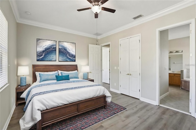 bedroom with ceiling fan, wood finished floors, visible vents, baseboards, and crown molding