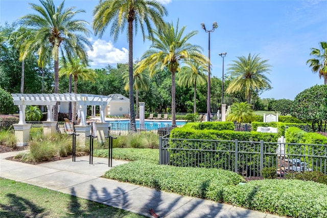 view of nearby features featuring a swimming pool and a pergola