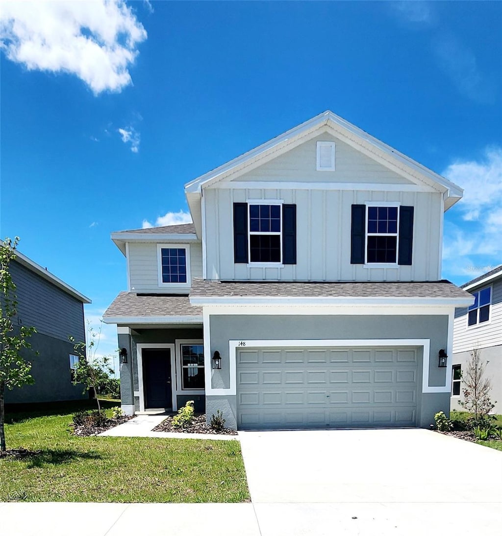 view of front of home with a garage and a front yard