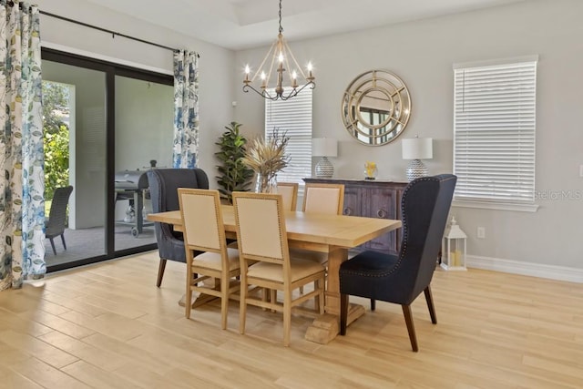 dining space with an inviting chandelier and light wood-type flooring