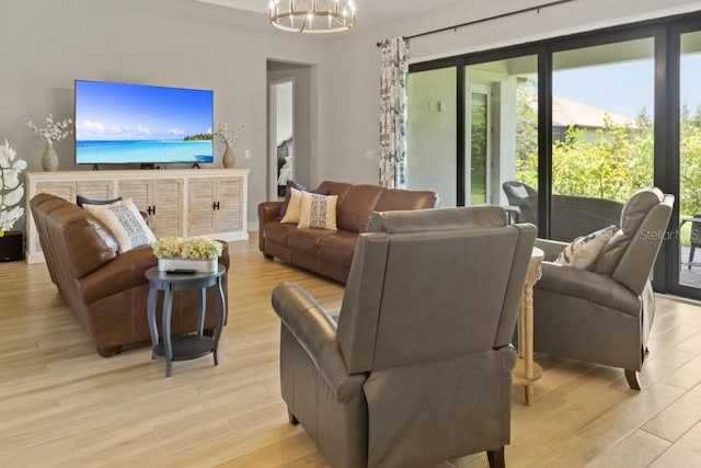 living room featuring light hardwood / wood-style floors and a notable chandelier