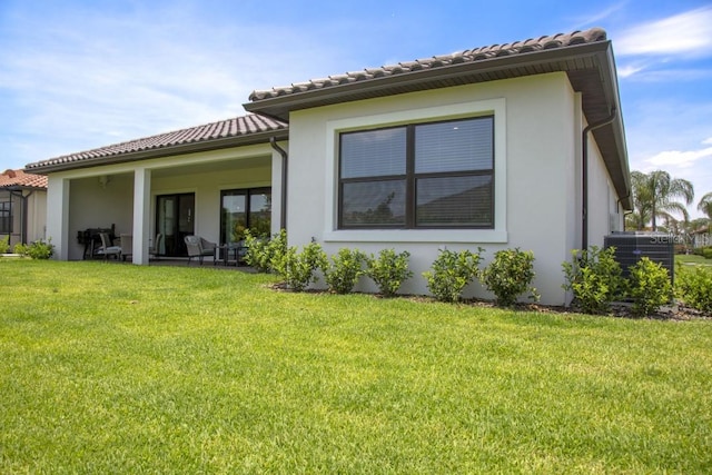 back of house with a lawn