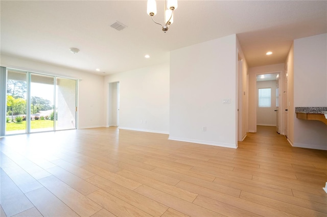 unfurnished room with light wood-type flooring