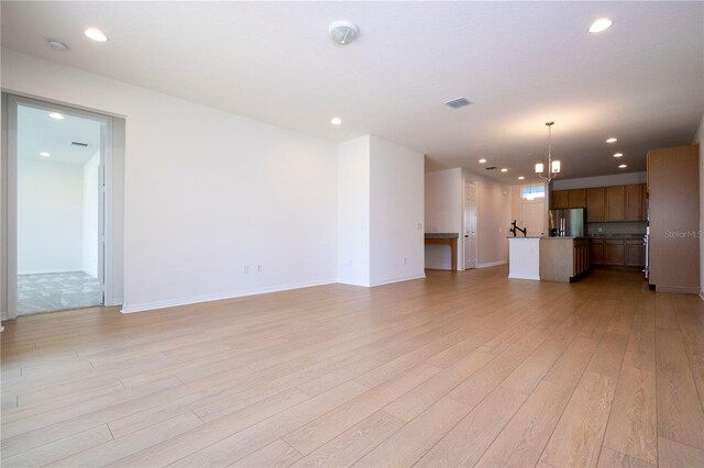 unfurnished living room with light hardwood / wood-style floors