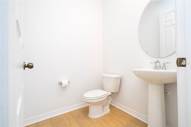 bathroom featuring hardwood / wood-style floors and toilet