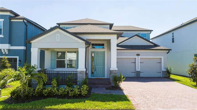 view of front facade with a garage and covered porch