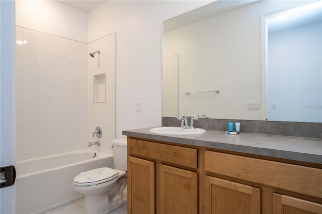 full bathroom featuring tile flooring, toilet, large vanity, and tiled shower / bath combo