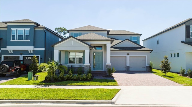 view of front of home with a garage and a front lawn