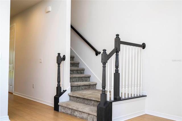 stairs featuring hardwood / wood-style flooring