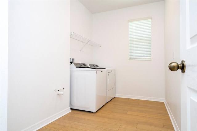 washroom featuring light hardwood / wood-style flooring and independent washer and dryer