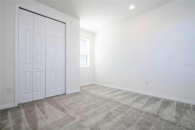 unfurnished bedroom with a closet and carpet flooring