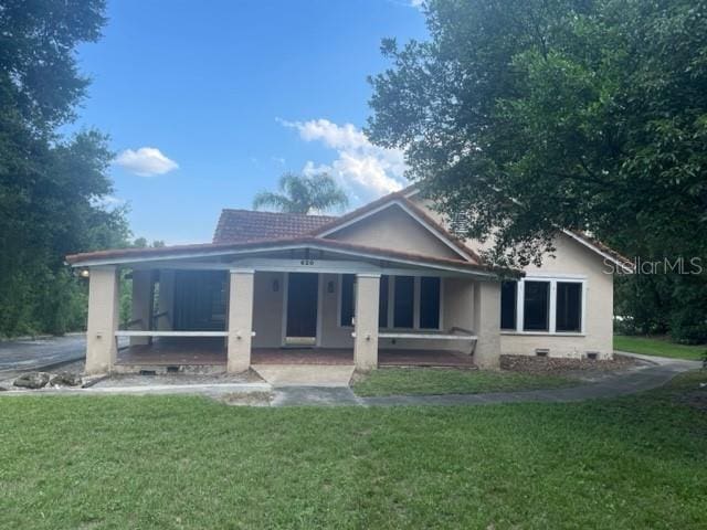 rear view of house with a lawn