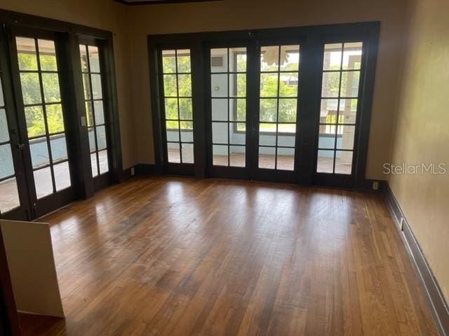 doorway to outside featuring french doors and dark hardwood / wood-style floors