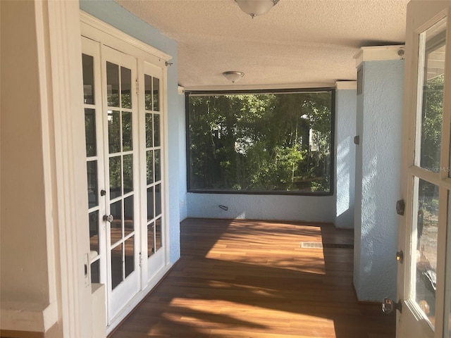 unfurnished sunroom with french doors and a wealth of natural light