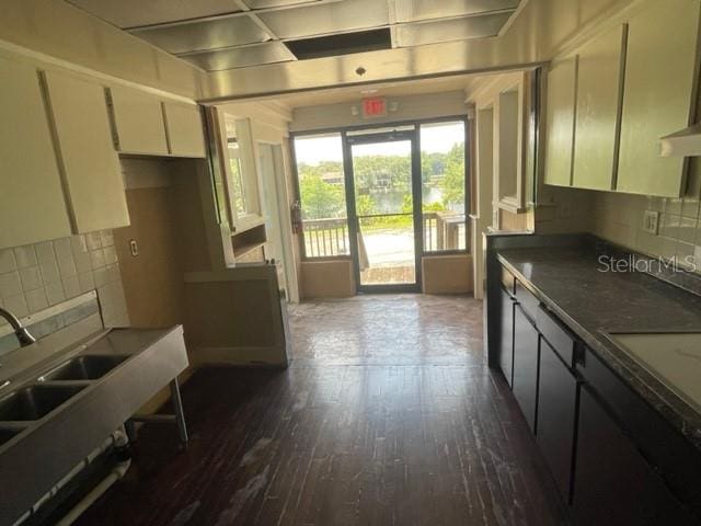 kitchen featuring cream cabinetry, dark hardwood / wood-style flooring, sink, and tasteful backsplash