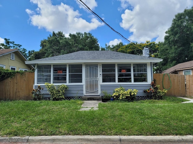 bungalow-style home with a front lawn