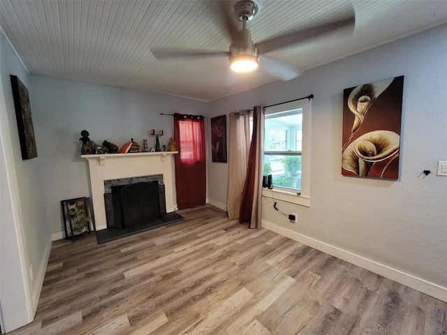 living room with a fireplace, ceiling fan, and hardwood / wood-style flooring