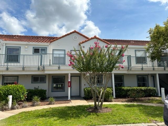 view of front of property with a balcony and a front lawn