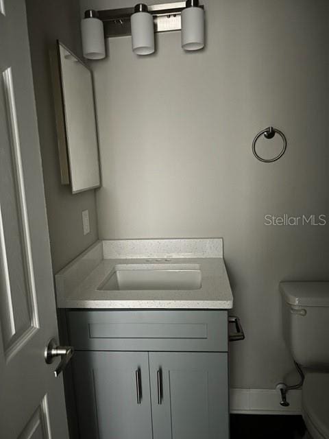 bathroom featuring vanity and toilet