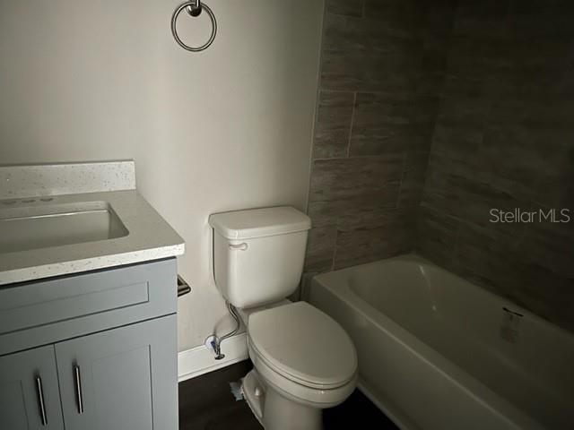 bathroom featuring toilet and vanity