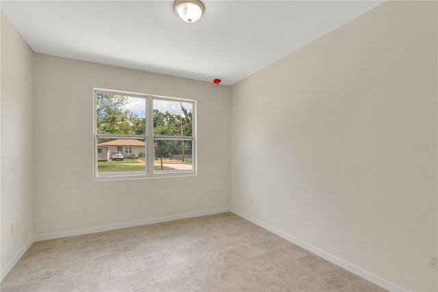 unfurnished room with light tile floors