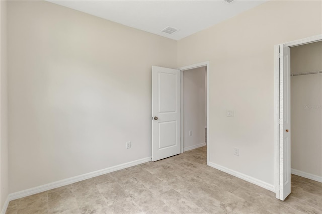 unfurnished bedroom featuring light tile flooring