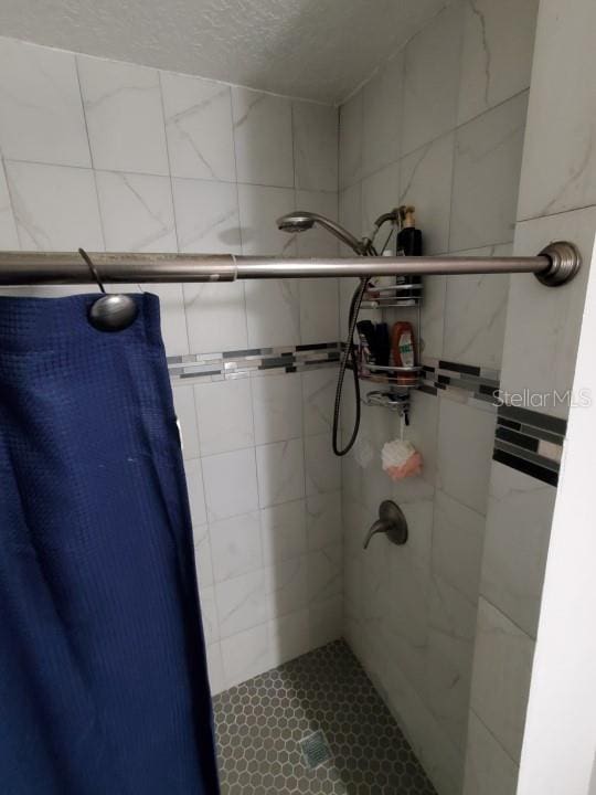 bathroom with a tile shower