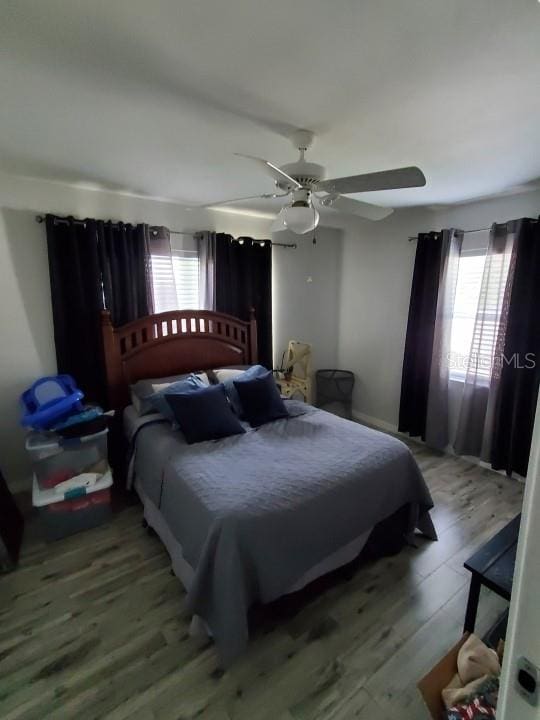 bedroom with hardwood / wood-style floors and ceiling fan