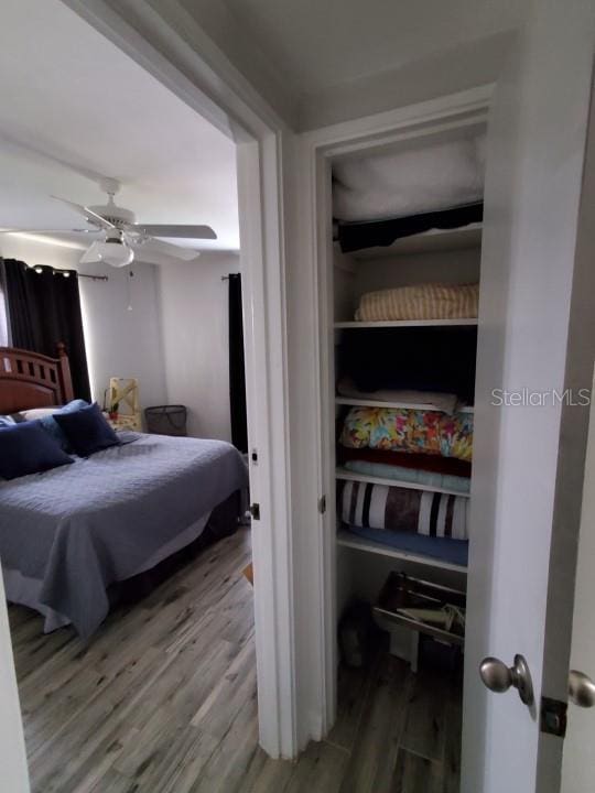 bedroom with wood-type flooring and ceiling fan