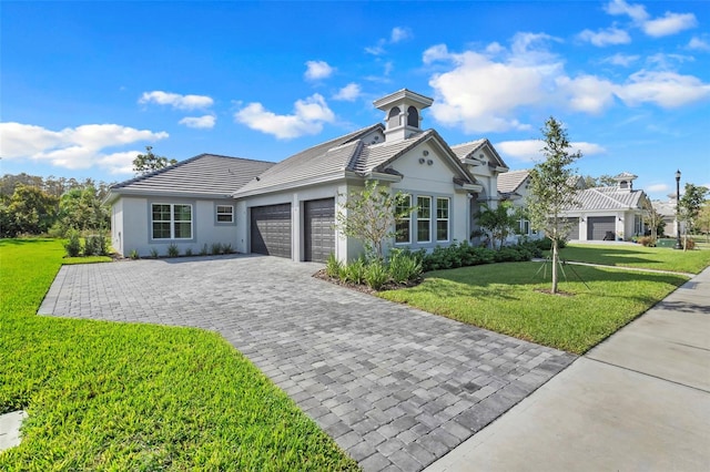 view of front facade featuring a front yard and a garage