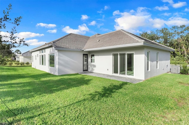 rear view of property featuring a patio area and a lawn