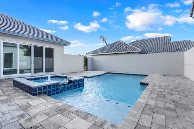 view of swimming pool with an in ground hot tub and a patio area