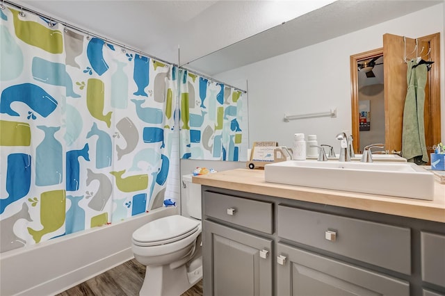 full bathroom featuring shower / bath combination with curtain, toilet, vanity, and hardwood / wood-style flooring