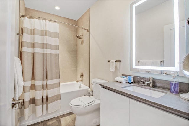 full bathroom with vanity, shower / bath combo with shower curtain, and toilet