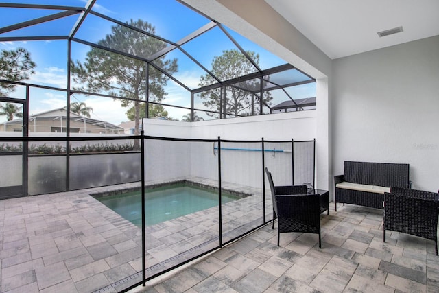 view of swimming pool featuring a patio and a lanai