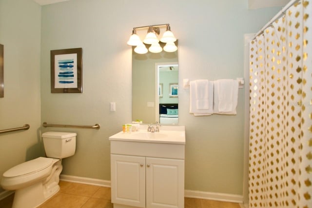 bathroom featuring tile patterned floors, walk in shower, vanity, and toilet