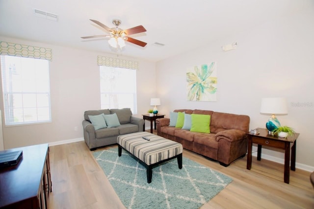 living room with ceiling fan and light hardwood / wood-style flooring