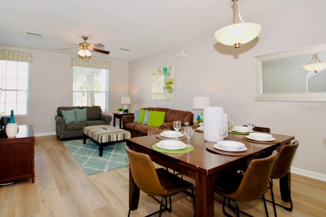 dining area with light hardwood / wood-style floors and ceiling fan