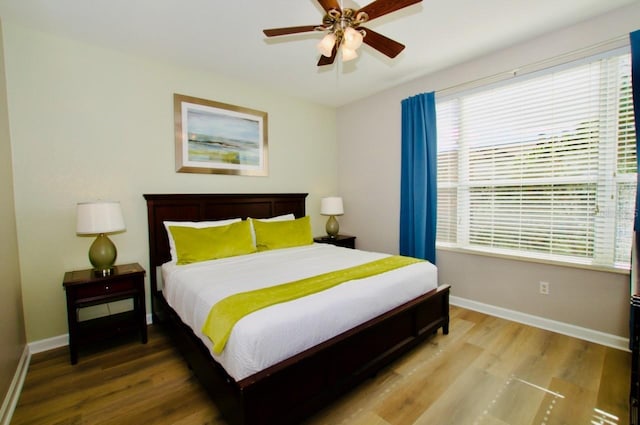 bedroom with hardwood / wood-style flooring and ceiling fan