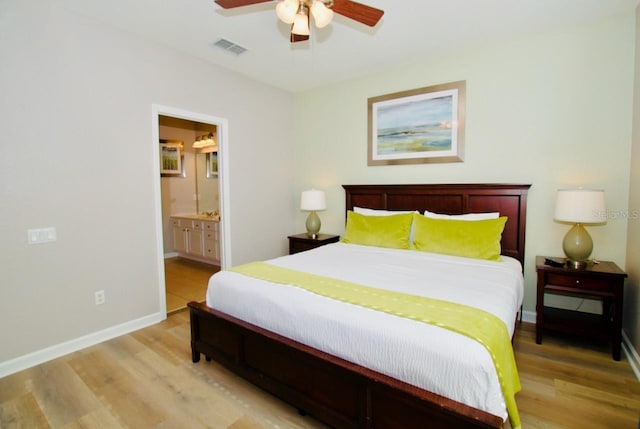 bedroom with connected bathroom, ceiling fan, and light hardwood / wood-style floors