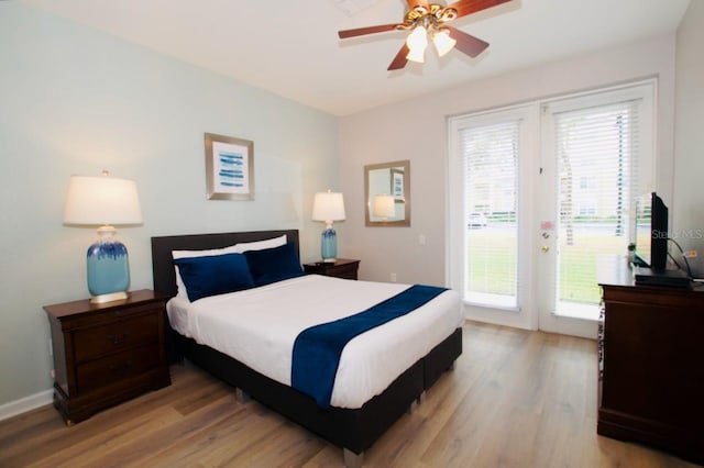 bedroom with access to exterior, light wood-type flooring, multiple windows, and ceiling fan