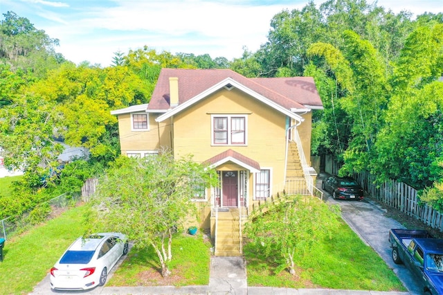 victorian-style house featuring a front yard