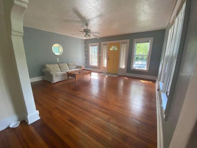 foyer entrance with plenty of natural light, ceiling fan, a textured ceiling, and dark hardwood / wood-style flooring