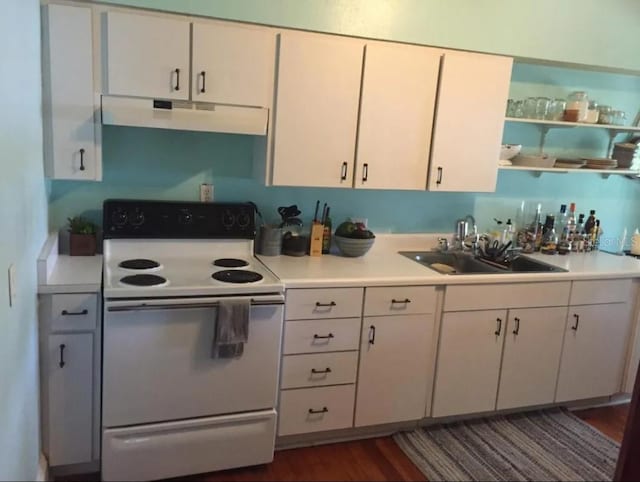 kitchen with white range with electric cooktop, sink, and white cabinets