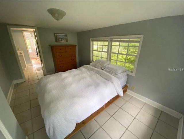 bedroom featuring light tile floors