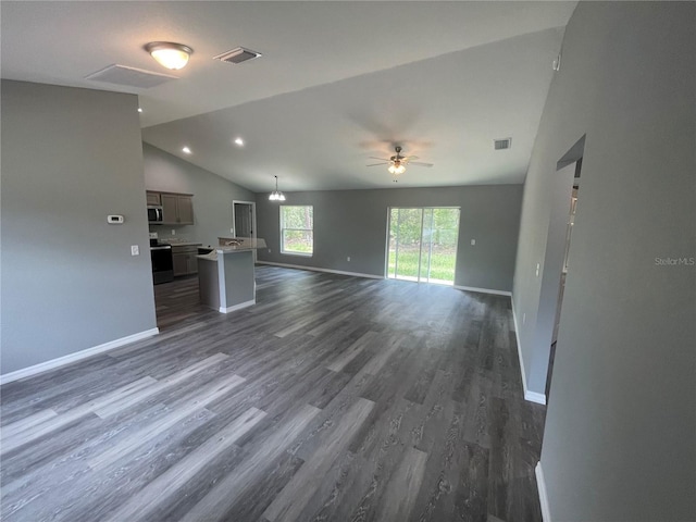 unfurnished living room featuring vaulted ceiling, dark hardwood / wood-style floors, and ceiling fan