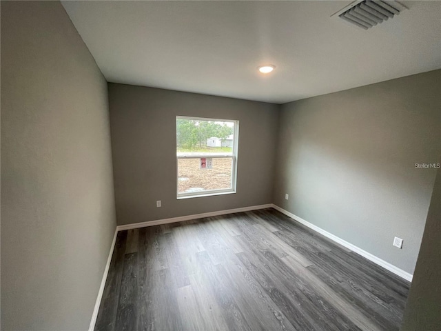 empty room with dark hardwood / wood-style floors