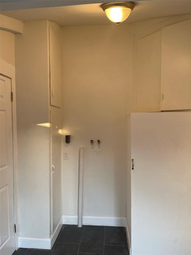 laundry room featuring hookup for a washing machine and dark tile floors