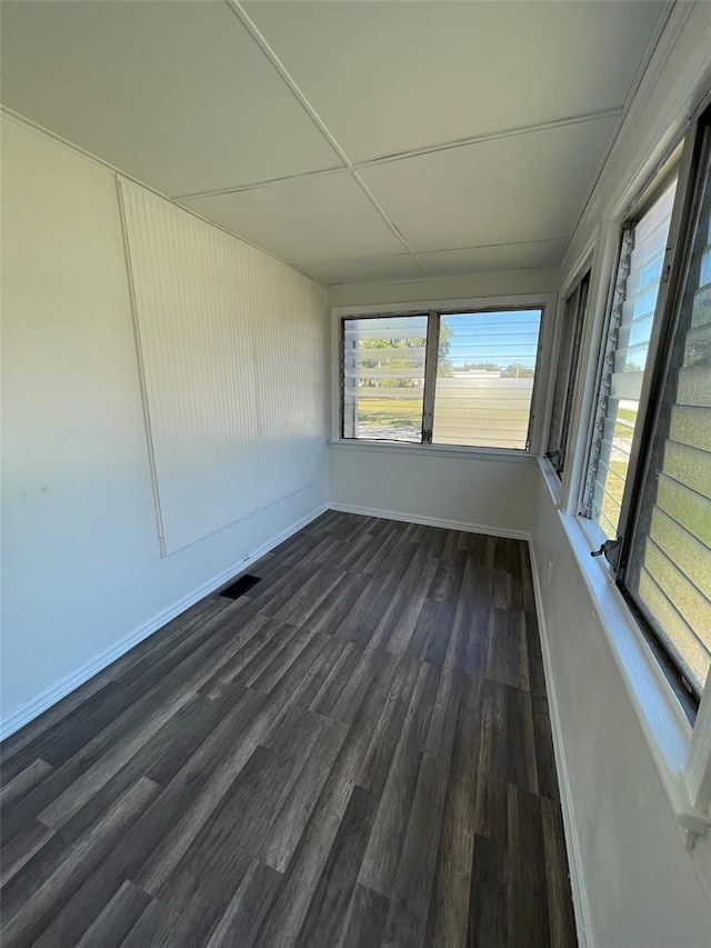 unfurnished room with dark hardwood / wood-style flooring